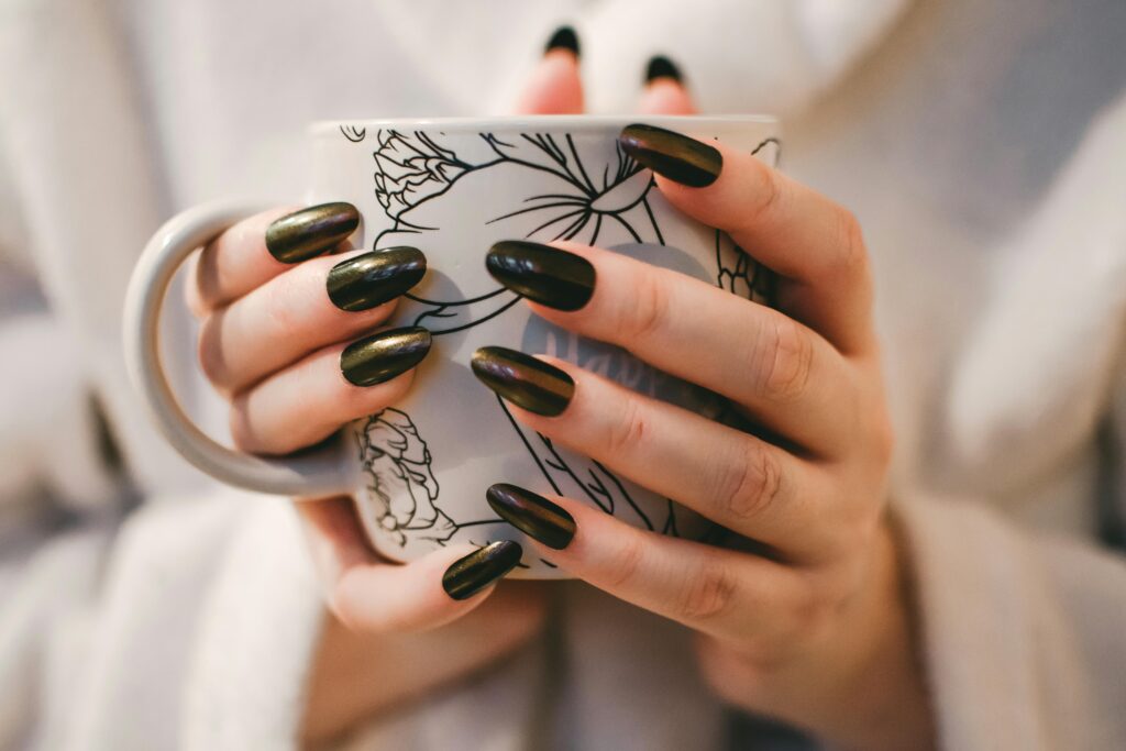 pexels-photo-851219-851219 A close-up of manicured hands holding a decorative mug, perfect for lifestyle and coffee themes.